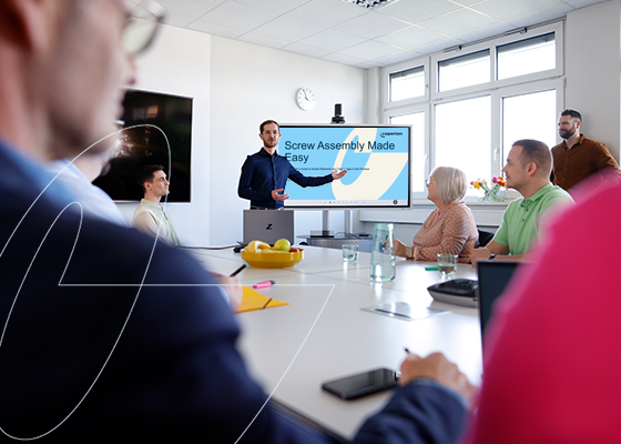 Coperion-Experte gibt Schulung vor einer Kundengruppe in Meetingraum