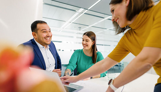 Coperion employees laughing in a meeting