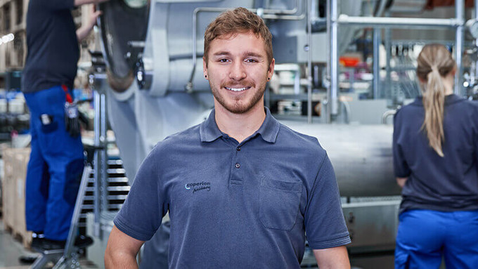 Coperion industrial mechanic standing in front of Water Ring Pelletizer