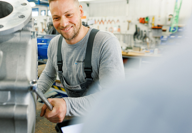 Coperion employee assembling and inspecting a WZK diverter valve
